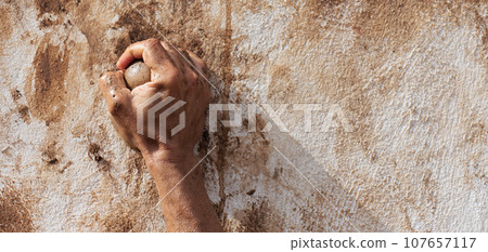 Mud race runners, obstacles during extreme obstacle race. Detail of a hand overcoming an obstacle Mud race runners, obstacles during extreme obstacle race. Detail of a hand overcoming an obstacle 107657117