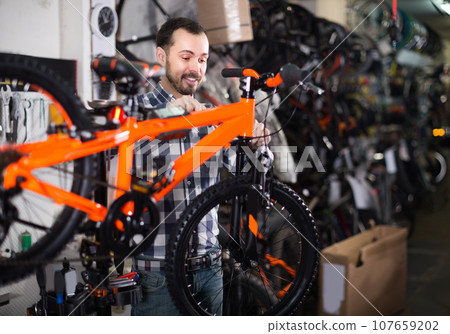 Male 28-39 years old is working on master bicycle assembly Male 28-39 years old is working on master bicycle assembly 107659202