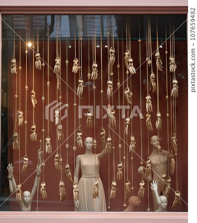 some manne in a window with gold chains hanging from it's sides and other mannes on the windows some manne in a window with gold chains hanging from it's sides and other mannes on the windows 107659482