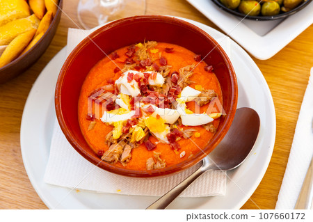 traditional spanish soup with eggs and meat for lunch 107660172