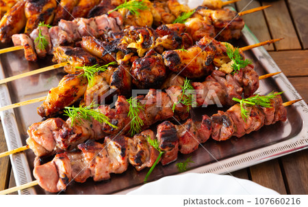 Tasty barbecue pork and chicken closeup Tasty barbecue pork and chicken closeup 107660216