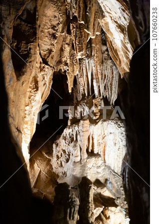 Stalactites, stalagmites and streak formations in cave of Balzarca. Moravian Karst.  107660238