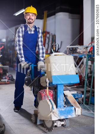 Worker is using gas saw for construction work Worker is using gas saw for construction work 107660685