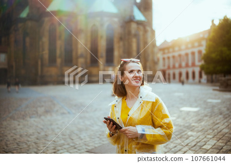 woman in Prague having walking tour, using phone and walking 107661044