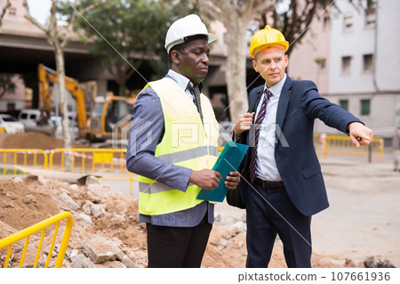 Young foreman shows someting to the african-american worker 107661936