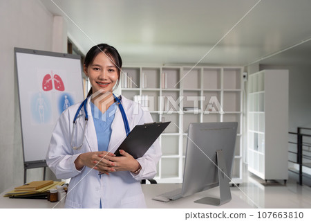 Doctor woman with clipboard for medical review, data research and healthcare in hospital. Happy female physician, and plan health Doctor woman with clipboard for medical review, data research and healthcare in hospital. Happy female physician, and plan health 107663810