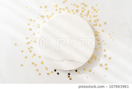 White marble cosmetic podium product design and Christmas golden stars confetti White marble cosmetic podium product design and Christmas golden stars confetti 107663961