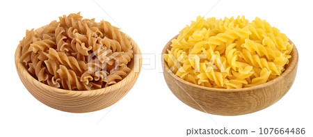 Wolegrain fusilli pasta from durum wheat in wooden bowl isolated on white background with full depth of field. 107664486