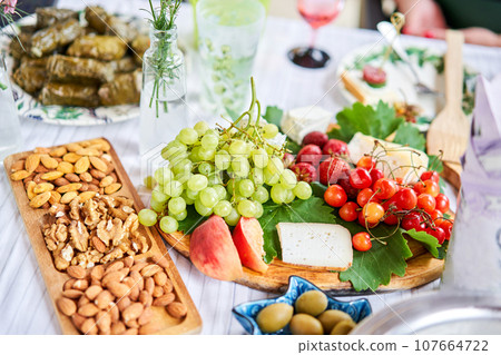 A covered buffet table for a master class. Cheeses, fruits and nuts. Master class and cheese tasting 107664722