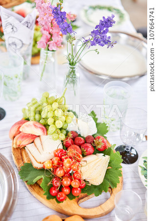 A covered buffet table for a master class. Cheeses, fruits and nuts. Master class and cheese tasting 107664741