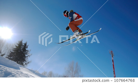 Skiers athletes compete going down from ski mountain. AI generated. 107664768