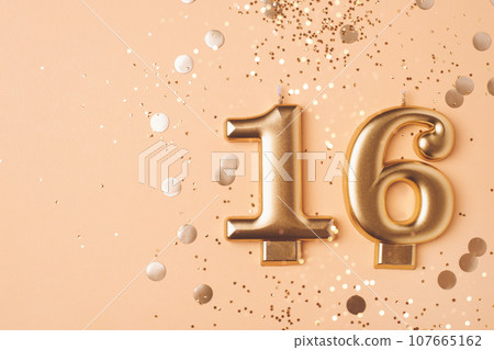 Gold candles in the form of number sixteen. Gold candles in the form of number sixteen. 107665162