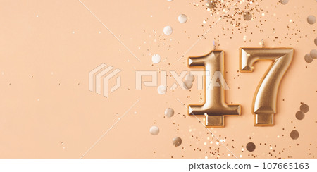 Gold candles in the form of number seventeen. 107665163