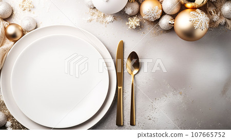 Modern holiday table setting, white empty plates, decorations from glass shiny balls, on a light table Modern holiday table setting, white empty plates, decorations from glass shiny balls, on a light table 107665752
