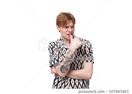 young smart man with red hair dressed in a short sleeve shirt posing on a white background young smart man with red hair dressed in a short sleeve shirt posing on a white background 107665861