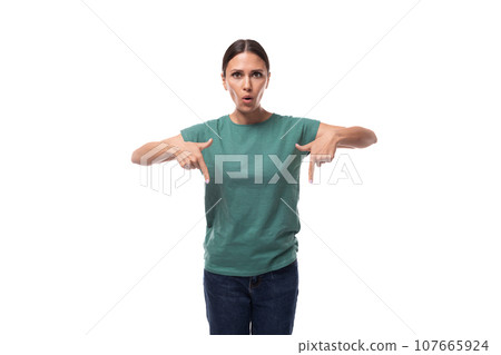 young surprised black-haired woman with collected hair dressed in a basic t-shirt and jeans points young surprised black-haired woman with collected hair dressed in a basic t-shirt and jeans points 107665924