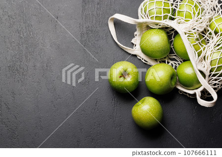 Mesh bag with fresh green apples Mesh bag with fresh green apples 107666111