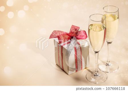 Two champagne glasses and gift box 107666118