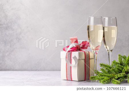 Two champagne glasses and gift box 107666121