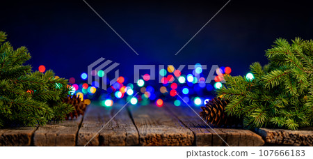 Christmas tree branches with pine cones and garland bokeh Christmas tree branches with pine cones and garland bokeh 107666183
