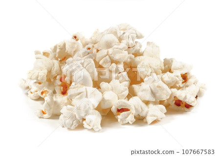 A bunch of fresh popcorn closeup on white. Salty popcorn. Top view A bunch of fresh popcorn closeup on white. Salty popcorn. Top view 107667583