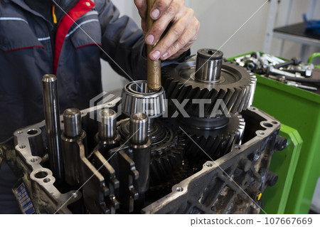 An auto mechanic repairs a truck engine. Service of trucks in the garage. Repair and diagnostics, Close-up. An auto mechanic repairs a truck engine. Service of trucks in the garage. Repair and diagnostics, Close-up. 107667669