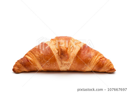 Fresh croissant on a white isolated background, closeup. French pastries 107667697
