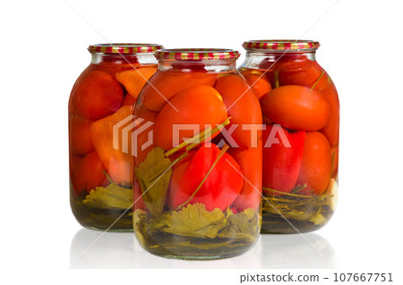 Jars of pickled tomatoes on a white background 107667751