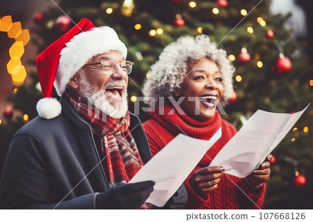 African American man and woman choir carolers singing traditional Christmas carols outdoors 107668126