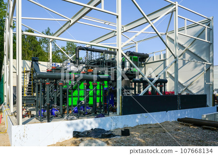 Steel framework of new wood chip biofuel heat power station before installing wall sandwich panels Steel framework of new wood chip biofuel heat power station before installing wall sandwich panels 107668134