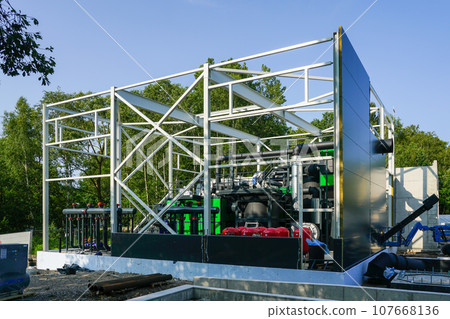 Steel framework of new wood chip biofuel heat power station before installing wall sandwich panels Steel framework of new wood chip biofuel heat power station before installing wall sandwich panels 107668136