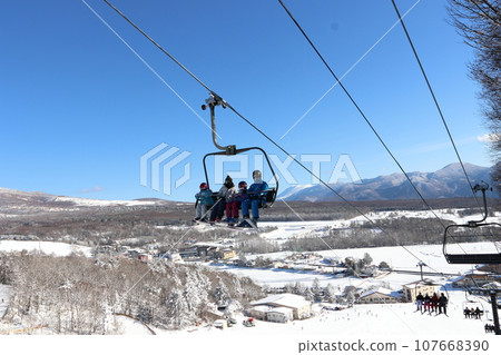 Ski resort - high-speed 4-person lift against the blue sky 107668390