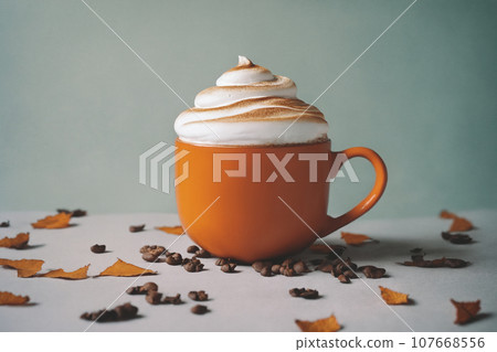 halloween decoration with latte and autumn leaves on a wooden table, still life, cozy, holiday background 107668556