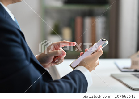 Side view of businessman searching information on the internet or chatting with friends in social media 107669515