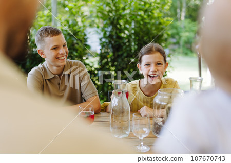 Young children enjoying family time in restaurant. Young children enjoying family time in restaurant. 107670743