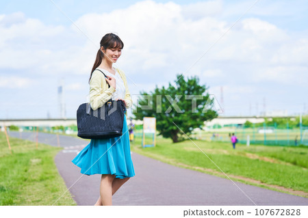 Young woman blue sky park 107672828