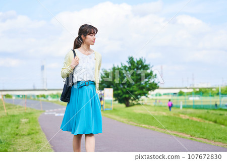 Young woman blue sky park 107672830