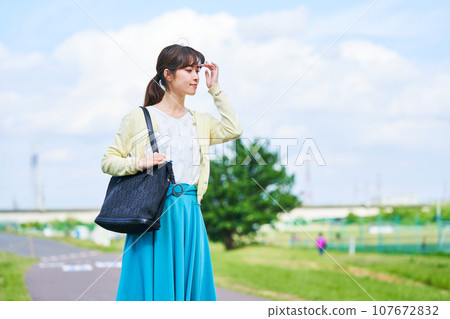 Young woman blue sky park 107672832