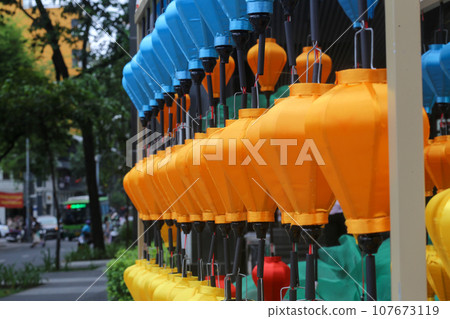 Traditional blue, yellow, and orange lanterns decorate the outside of the shopping center in Ho Chi Minh City Traditional blue, yellow, and orange lanterns decorate the outside of the shopping center in Ho Chi Minh City 107673119