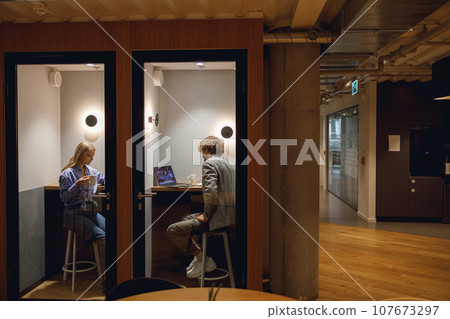 Two diverse business people working in modern coworking space 107673297