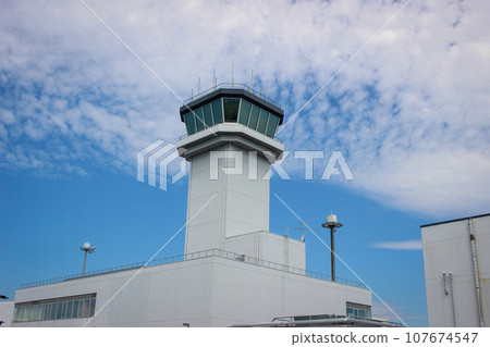 Airport control tower shining against the autumn sky Airport control tower shining against the autumn sky 107674547