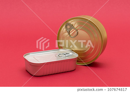 Unopened Tin Cans with Blank Edges on Red Background Unopened Tin Cans with Blank Edges on Red Background 107674817