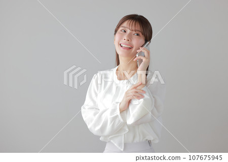 Young business woman happily calling 2 107675945