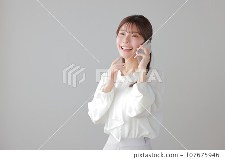 Young business woman happily making a phone call_with movement on the right hand 1 Young business woman happily making a phone call_with movement on the right hand 1 107675946