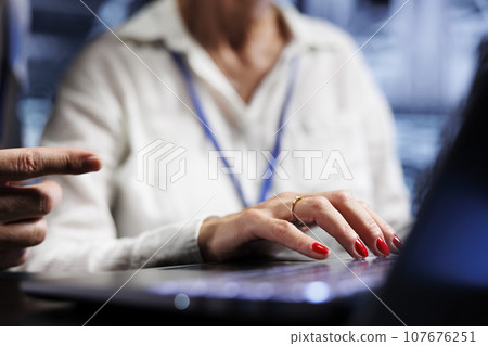 Efficient coworkers dealing with server cabinets system failures. Knowledgeable experts brainstorming ideas on how to best minimize data storage company downtime and prevent malfunctions, close up Efficient coworkers dealing with server cabinets system failures. Knowledgeable experts brainstorming ideas on how to best minimize data storage company downtime and prevent malfunctions, close up 107676251