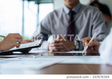 Business people teamwork with analysis cost graph on desk at meeting room 107676304