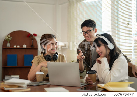 A smart Asian male student is helping his friends with math homework, tutoring his friends. 107676477