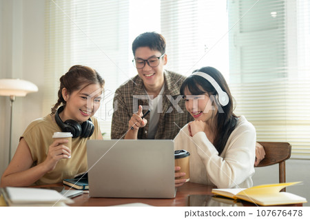 A smart Asian male student is helping his friends with math homework, tutoring his friends. 107676478