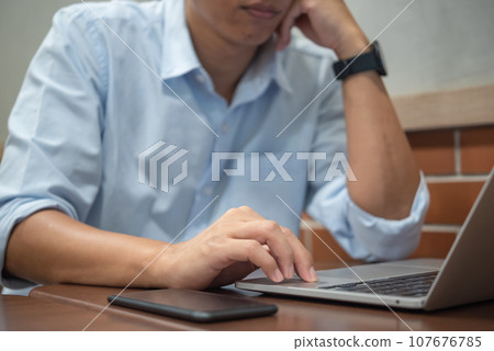 Person hands typing on laptop keyboard at the office. Business man hands typing online learning, internet marketing, searching the information and technology concept. Person hands typing on laptop keyboard at the office. Business man hands typing online learning, internet marketing, searching the information and technology concept. 107676785