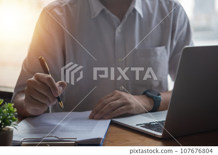 Hand Signing a Contract with Pen. business, finance, or legal projects, formal agreements and partnerships. 107676804